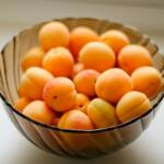 orange fruits in blue ceramic bowl